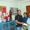 John Francis Mediano with Teresa Sepulveda handing the donation to Sr. Marcia.